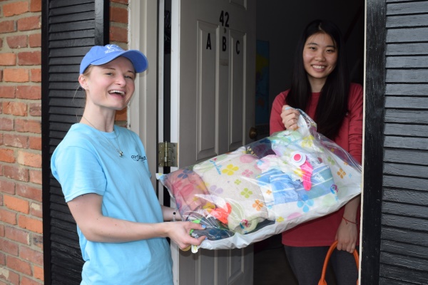 ShareFest volunteer picking up a donation from an off-campus residence